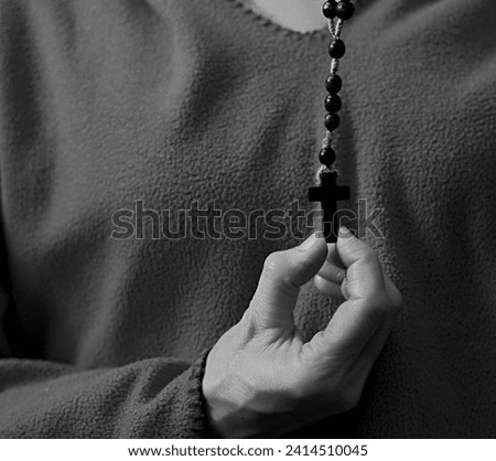 praying to god with hands together on grey black background with people stock image stock photo	