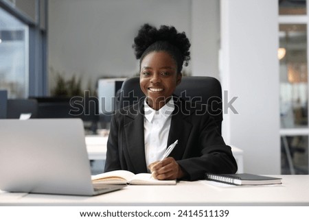 Happy woman working at table in office. Lawyer, businesswoman, accountant or manager