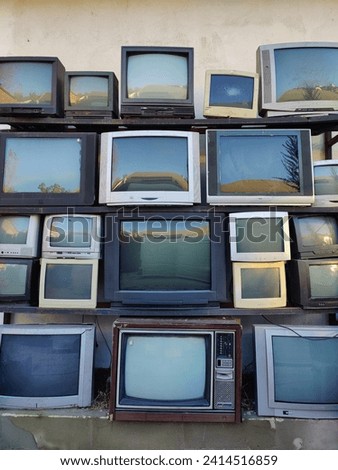 old televisions stacked on top of each other
