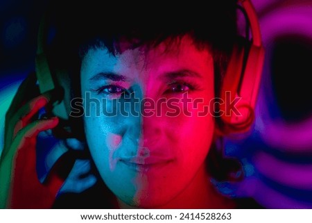 portrait of a woman listening to music with colorful light background