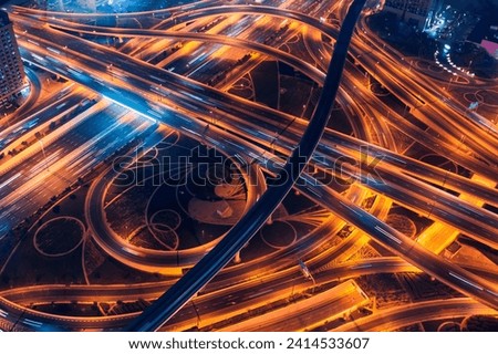 Aerial top view of amazing highway in Dubai, neon color. Royalty-Free Stock Photo #2414533607