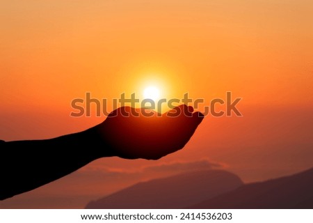 Silhouette of hand prayer person worship God with sunrise