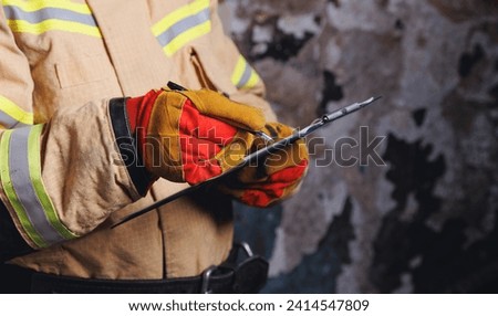 Fireman inspector conducts investigation to determine circumstances of fire in house and uses clipboard for report incident. Concept Insurance payments and checklist. Royalty-Free Stock Photo #2414547809