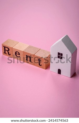 Small wooden house and the inscription for rent. Concept for sale, rental of real estate for a family. Real estate agency, sale of new houses and apartments