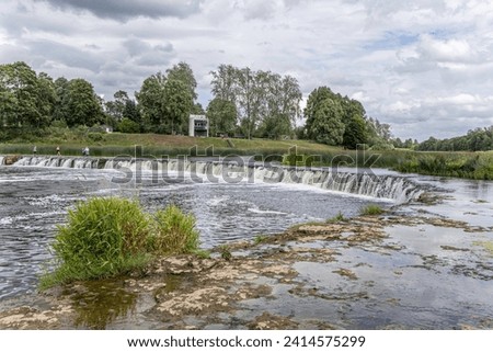 Kuldiga, Latvia - July 3, 2023: Venta Rapid waterfall. Ventas Rumba, the widest waterfall in Europe, Kuldiga, Latvia. Royalty-Free Stock Photo #2414575299
