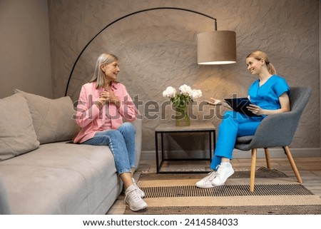 Doctor talking to patient providing professional consultation to elderly woman.