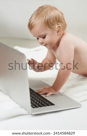 Laptop, games and baby on a floor with cartoon, streaming or subscription service in a house. Learning, child development and curious boy kid with computer for educational gaming, app and fun