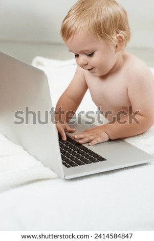 Baby, playing and learning in home on laptop with online games for education and elearning. Happy, child and relax with cartoon, movies or development of knowledge of technology for growth and fun