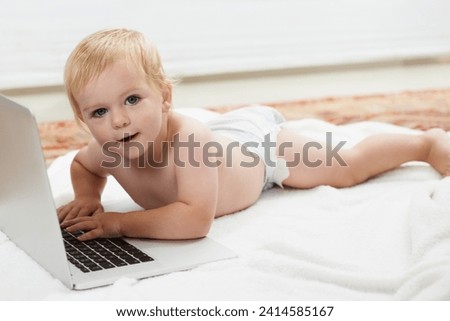 Baby, playing and learning on laptop in portrait on bed at home with online games for education. Happy, child and relax with cartoon, movies or development of knowledge of technology for growth
