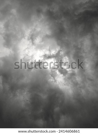 raw photo of Light centered between dark cloudy sky