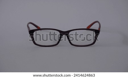 black frame reading glasses with colorful handles on a white background
