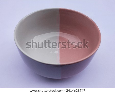 Two-tone ceramic bowl, white and pink on a white background. Royalty-Free Stock Photo #2414628747