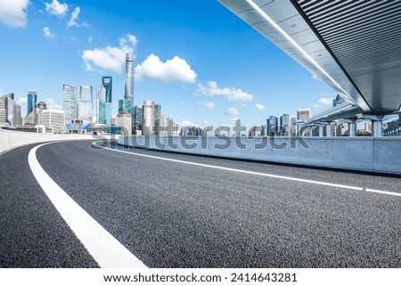 Asphalt highway road and pedestrian bridge with modern city buildings scenery in Shanghai