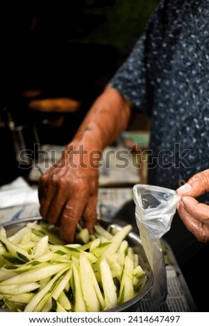 people doing traditional packaging of pickled food close up