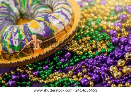 Mardi Gras King Cake with Baby and  Purple, Green, and Gold Decorations 