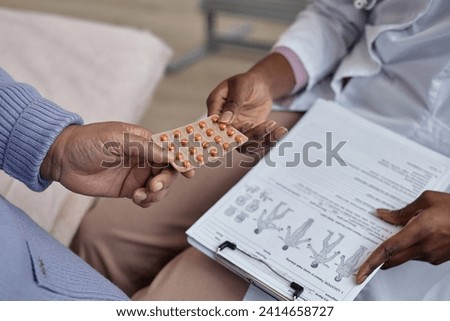 Close up shot unrecognizable doctor giving blister pack of prescribed pills to patient during visit in hospital Royalty-Free Stock Photo #2414658727