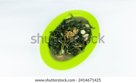 Photo of stir-fried kale with a white background.