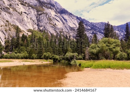 You can see how the river is drying up but it leaves a beautiful group of trees that do not lose their color like the mountains. Royalty-Free Stock Photo #2414684167