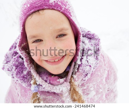 Child in winter. Happy girl on snow