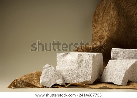 Granite stone podium decorated with sackcloth on beige background