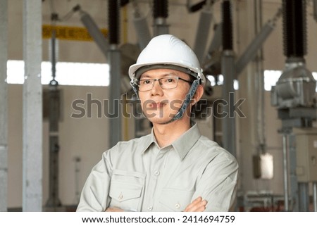 Engineers technicians man wearing professional helmets working in powerhouse or power plant. Royalty-Free Stock Photo #2414694759