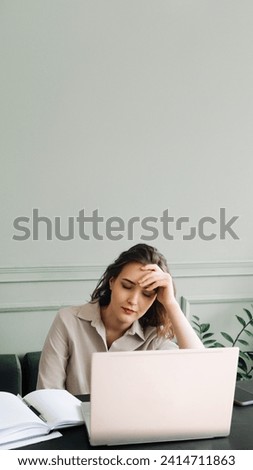 Work-Induced Weariness. Young Woman Suffers from Overwork and Stress. Modern-Day Struggles. Woman Overwhelmed by Overwork and Stress. Young Woman Sleeps at Laptop, Overworked and Stressed. Royalty-Free Stock Photo #2414711863