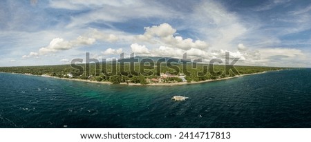 Scenic Panorama Aerial Drone Picture of the coast of Dauin, Dumaguete, Philippines with Mount Talinis in the background