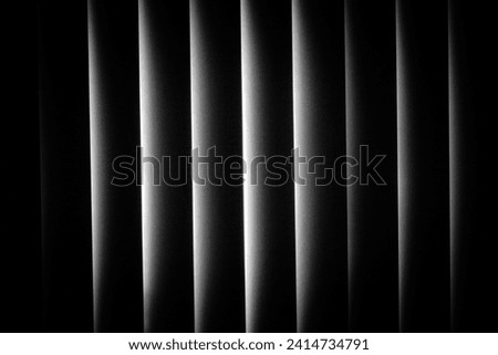 An abstract picture of window blinds in black and white. 