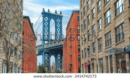  Brooklyn, NYC. Manhattan Bridge between Manhattan and Brooklyn over East River seen from a narrow alley enclosed by two brick buildings.