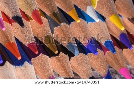 Macro close-up of the sharpened tips of colorful wooden crayons