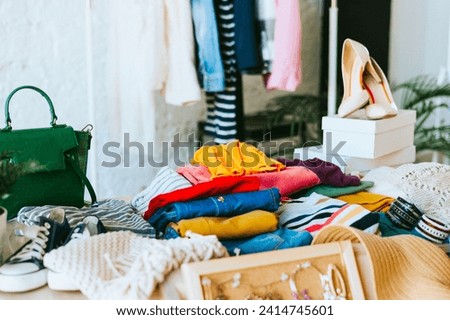 swap party for try on clothes, bags, shoes and accessories, garage sale, second hand and zero waste life, eco-friendly approach to consumption, clothes hanger in loft interior Royalty-Free Stock Photo #2414745601