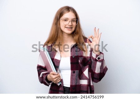 Teenager student Russian girl isolated on white background showing ok sign with fingers