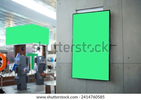 Blank green screen on television or digital media billboard for advertising at department store.