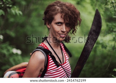 Gritty Woman Survival Adventurer Portrait With machete Outdoors in a Forest Wilderness Royalty-Free Stock Photo #2414762199