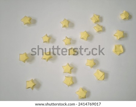 Yellow star origami on white paper