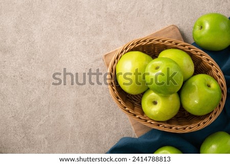 Fresh juicy delicious Taiwanese Milk Indian Jujube fruit in a basket on gray table background. Royalty-Free Stock Photo #2414788813