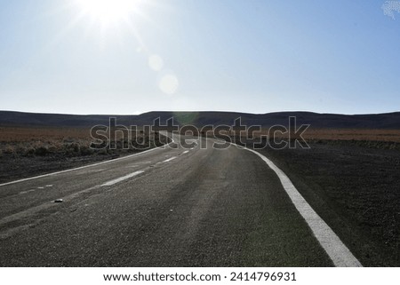 Lonely road curve desert bokeh chile South America. High quality photo Royalty-Free Stock Photo #2414796931
