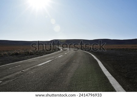 Lonely road curve desert bokeh chile South America. High quality photo Royalty-Free Stock Photo #2414796933