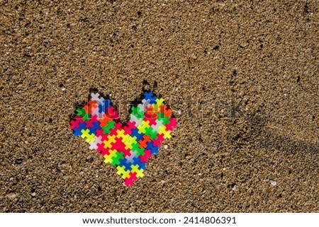 Puzzle heart: Love and connection depicted by colorful puzzle pieces on the beach, symbolizing a unique and special bond
