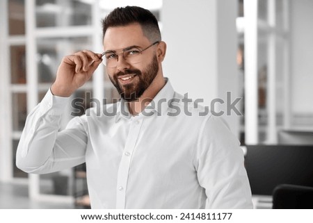 Portrait of smiling man in office. Lawyer, businessman, accountant or manager