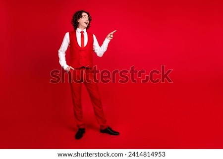 Full body size photo of elegant teen boyfriend invites girls for prom in college point finger empty space isolated on red color background