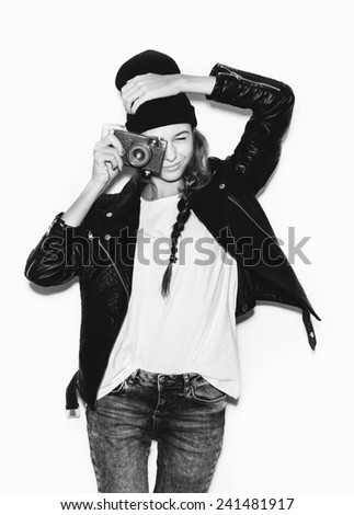 Young woman making photo using noname retro camera. black white portrait on White background not isolated