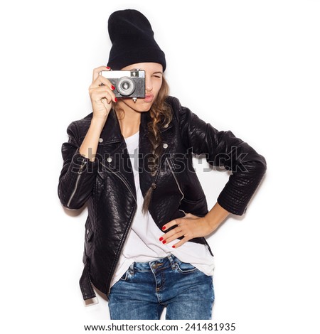 Pretty girl making photo using noname retro camera. White background, not isolated
