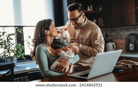 Parents with baby having video call online, conversation with relatives, communicating with friends