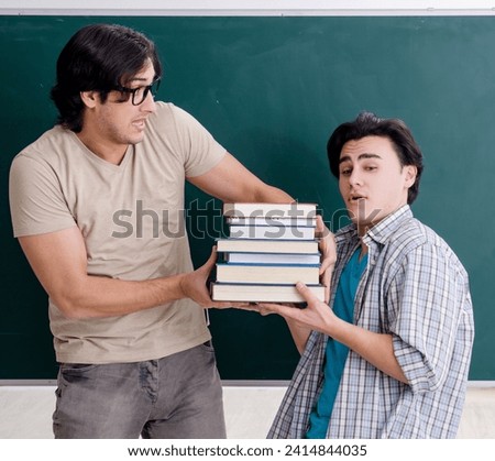 Two male students in the classroom Royalty-Free Stock Photo #2414844035
