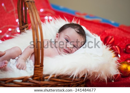 picture of a newborn baby curled up sleeping on a blanket 