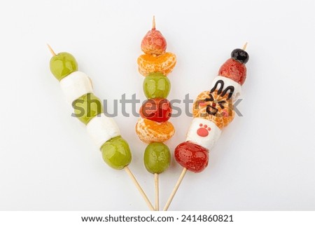Tanghulu, a fruit skewer Korean snack candy coated with sugar syrup Royalty-Free Stock Photo #2414860821