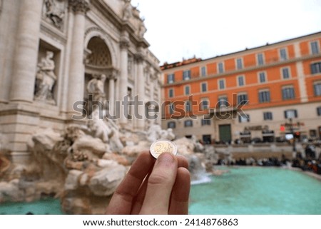 Coin toss into the Trevi Fountain, Rome. Royalty-Free Stock Photo #2414876863