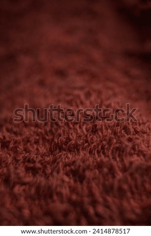 detail of the soft, stringy texture of a red towel