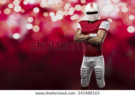 Football Player with a red uniform on a red lights background.